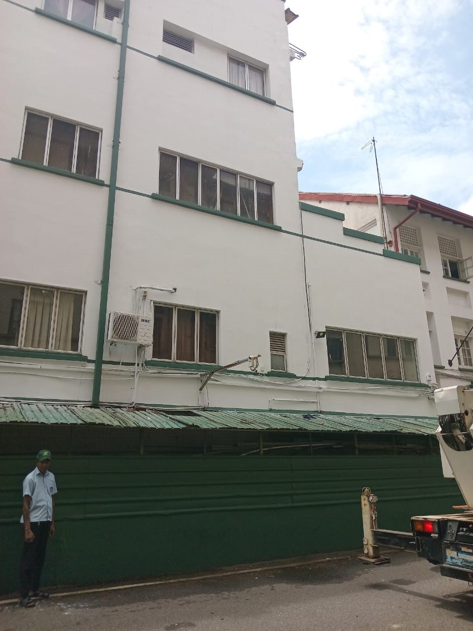 Freshly painted white exterior wall with green trim