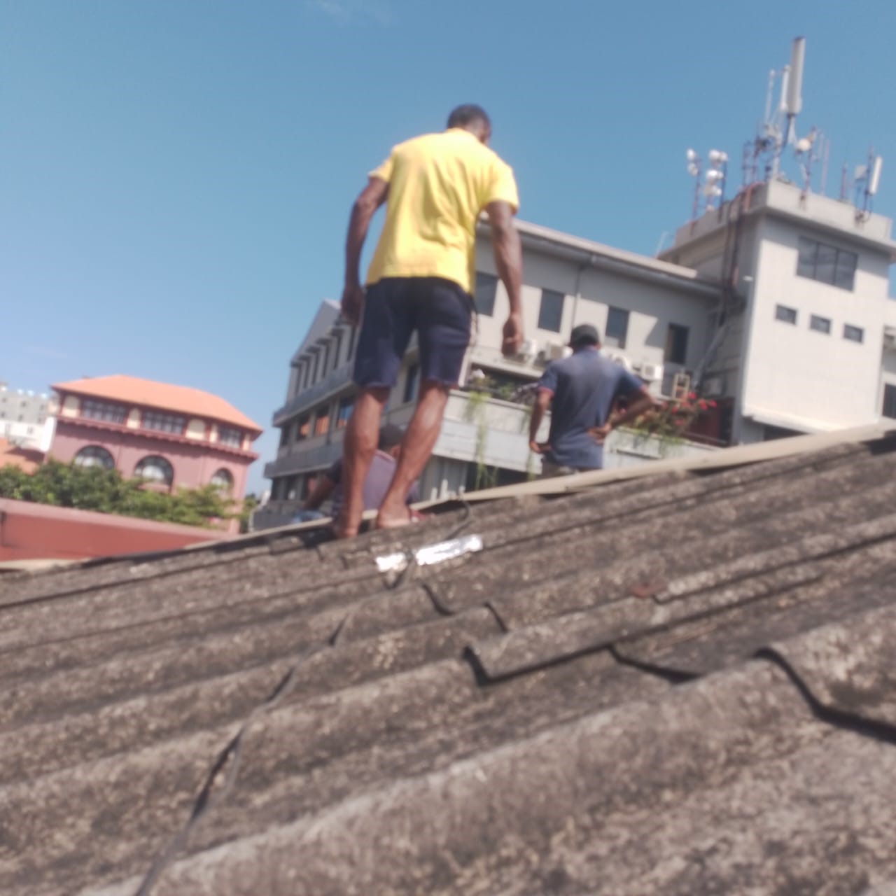 Workers inspecting a tiled roof